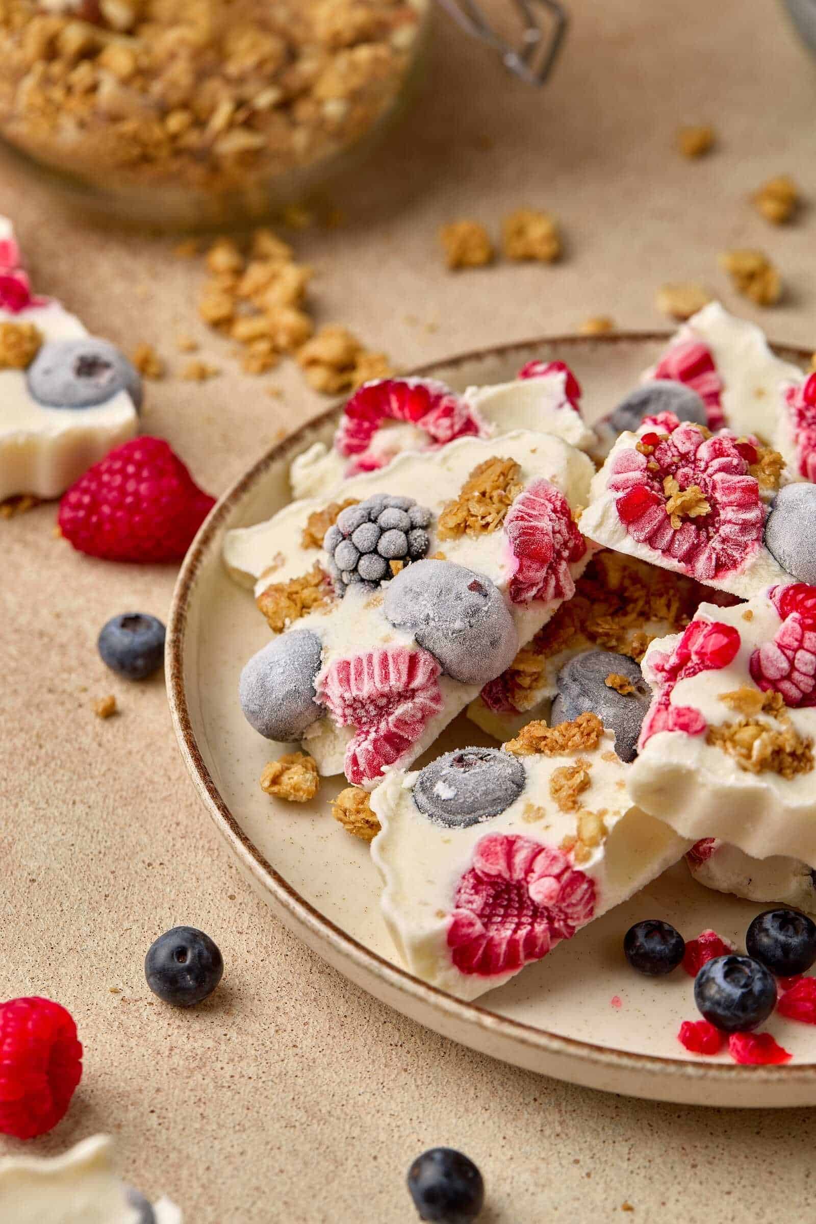 Delicious frozen yogurt with mixed berries and crunchy granola topping. Perfect healthy snack or dessert.