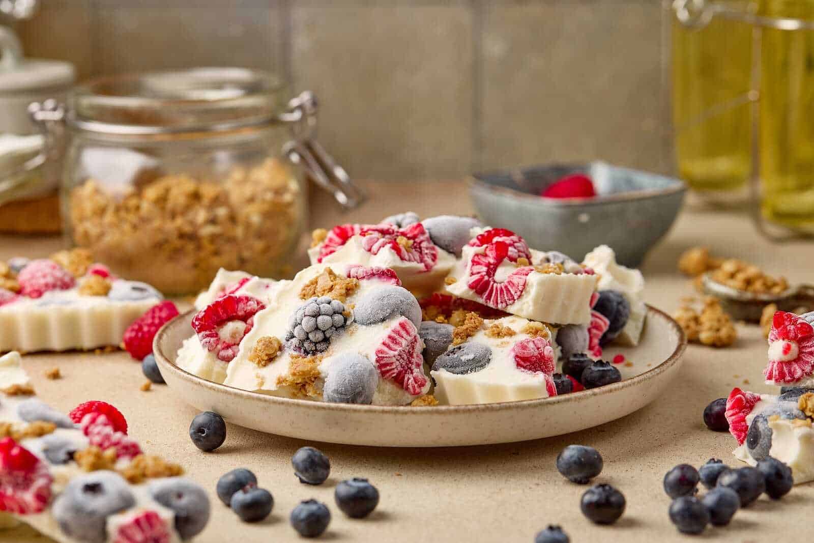 Delicious homemade berry yogurt parfait with fresh blueberries, raspberries, and granola crumbles for a healthy snack.
