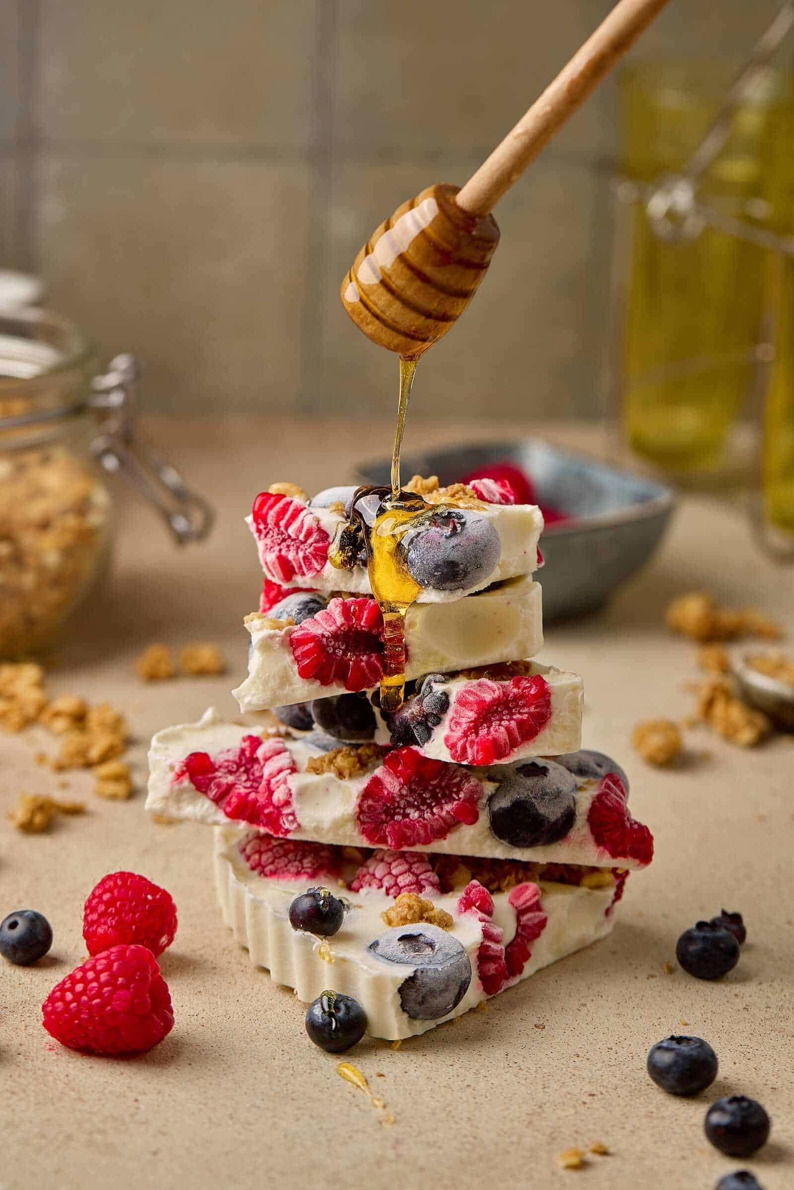 Healthy, colorful dessert featuring fresh berries and creamy yogurt on a rustic surface.