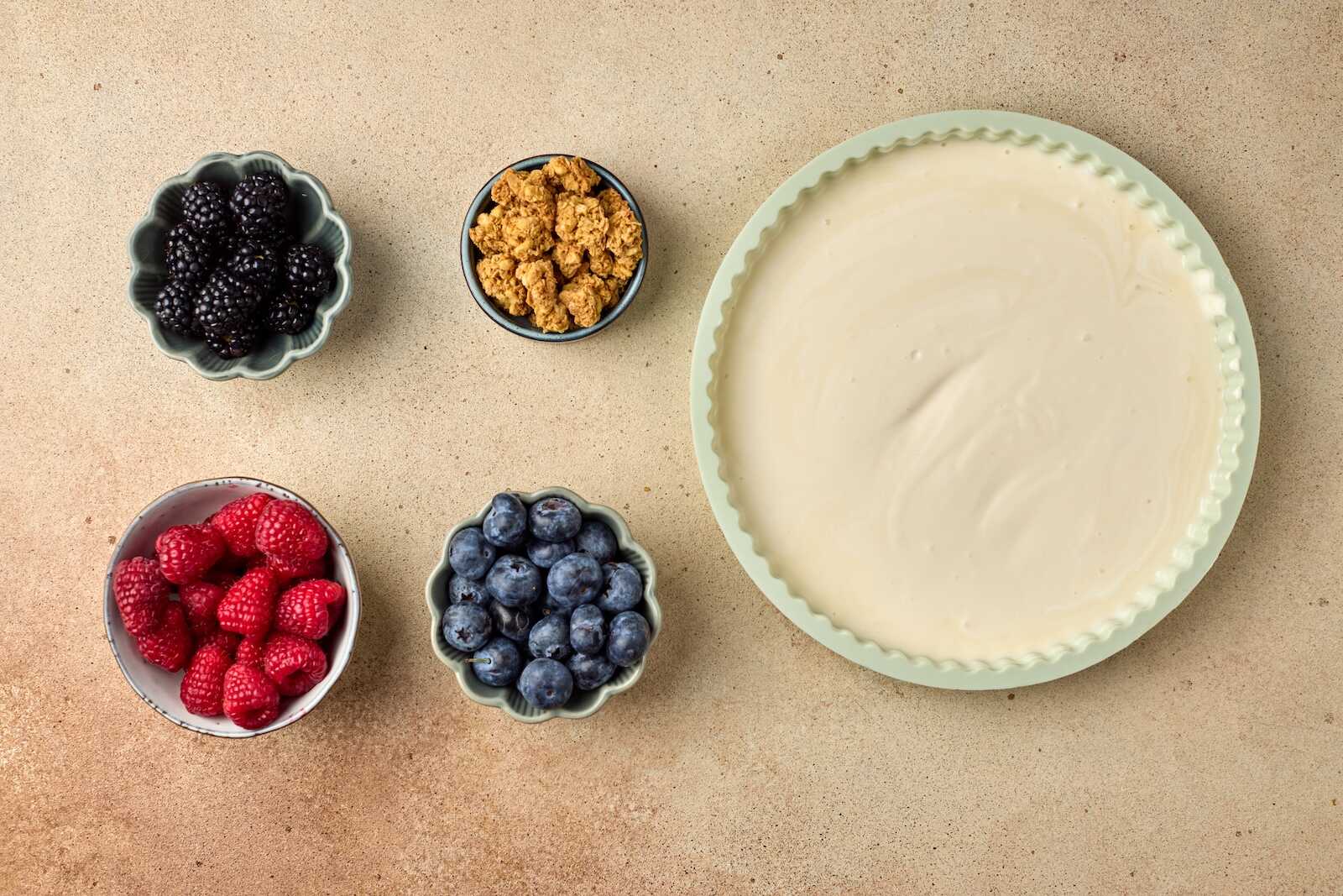 Fresh blackberries, raspberries, blueberries, crushed graham crackers, and cheesecake crust.