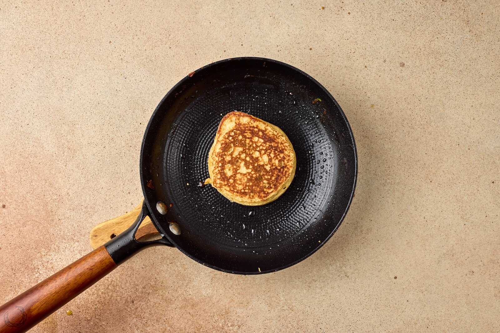 Delicious pancake being cooked in a frying pan, symbolizing nurturing and caring in surrogacy journeys.