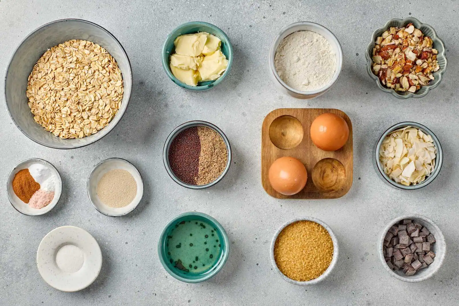 Healthy oatmeal ingredients including oats, butter, flour, eggs, chocolate, and spices.