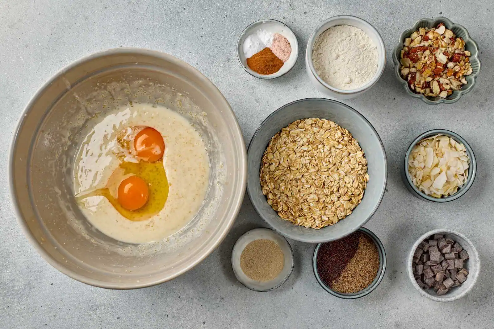 Eggs, oats, flour, and spices prepared for baking healthy oatmeal cookies from surrogacy mama source.